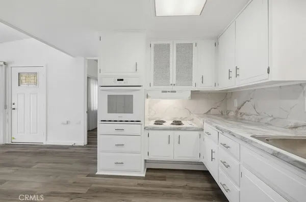 a view of a room with wooden floor