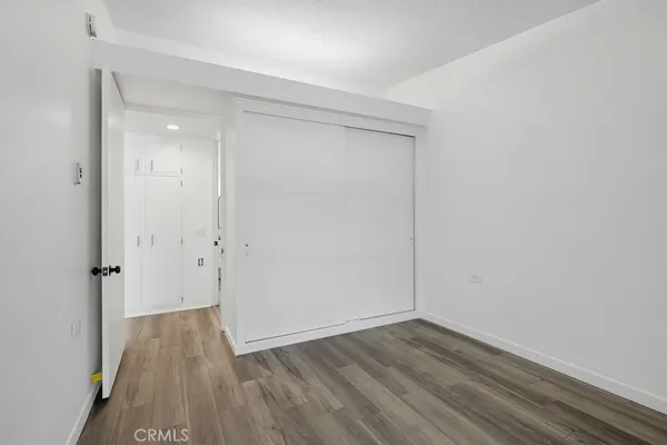 a bathroom with a granite countertop sink toilet and a mirror