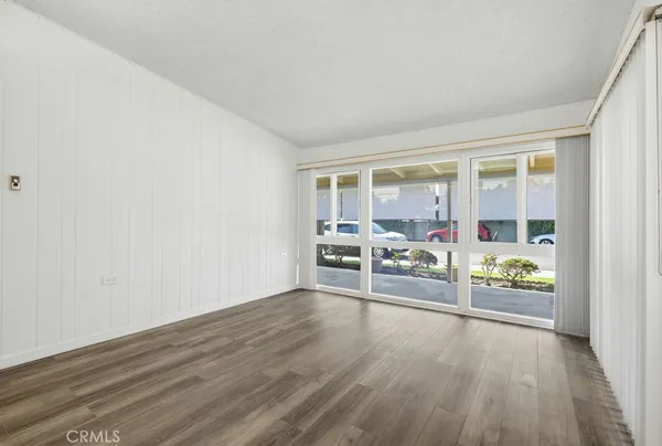 a view of a livingroom with wooden floor and a window