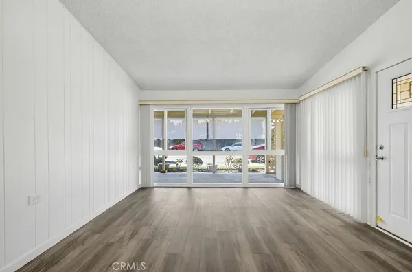 a view of an empty room and wooden floor