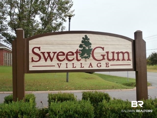 16976 Sugar Loop Foley, AL 36535 - Photo 2 of 16 Community / neighborhood sign featuring a yard