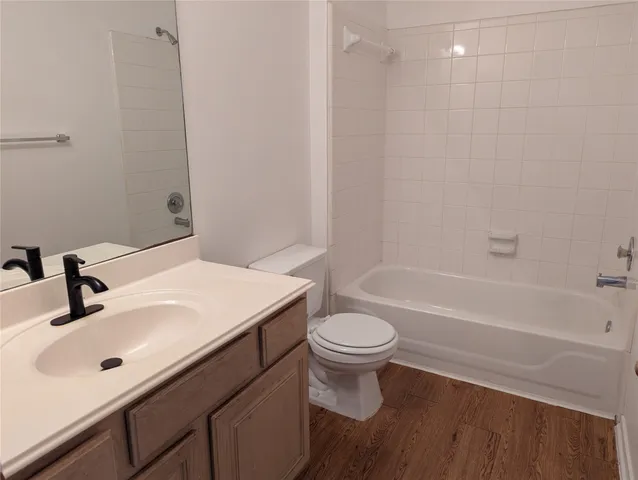 a bathroom with a sink a toilet and bathtub