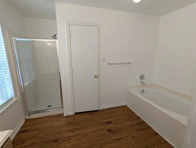 a bathroom with a bathtub and shower