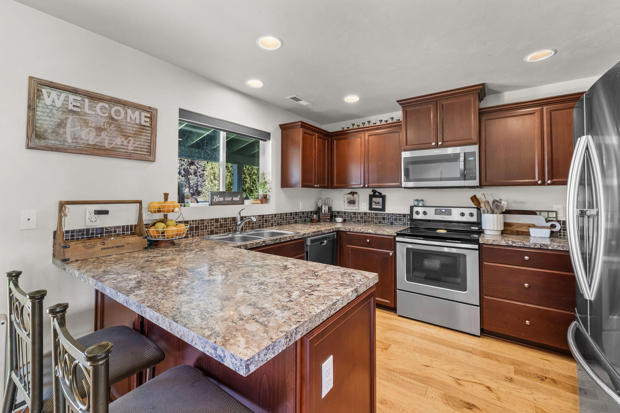 63639 Gentry Loop Bend, OR 97701 - Photo 12 of 40 a kitchen with stainless steel appliances granite countertop a stove refrigerator sink and microwave