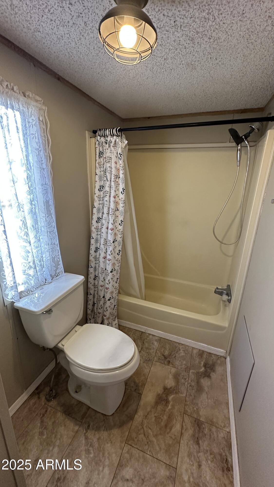 834 South Meridian Road, Unit 105 Apache Junction, AZ 85120 - Photo 17 of 48 a bathroom with a toilet and a shower