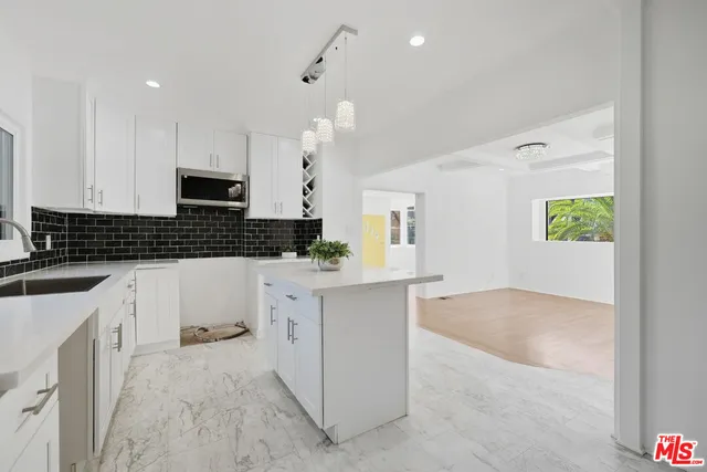 a kitchen with a sink stove and cabinets