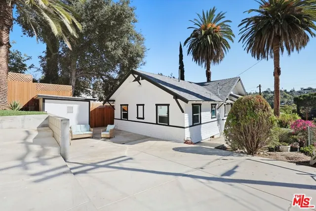 a house with palm tree in front of it