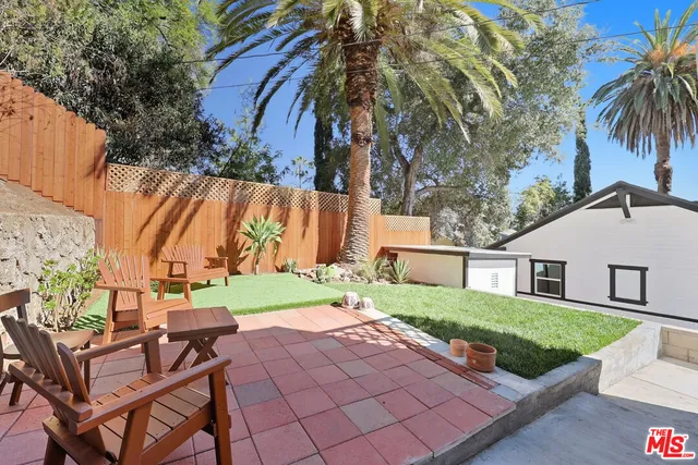 a view of backyard with swimming pool and outdoor seating