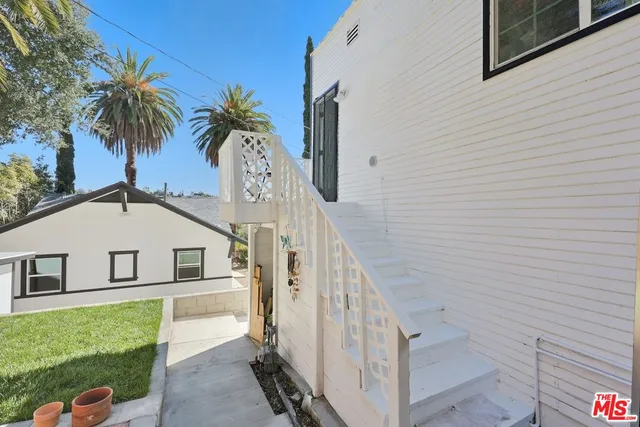 a white house with a white roof and a yard