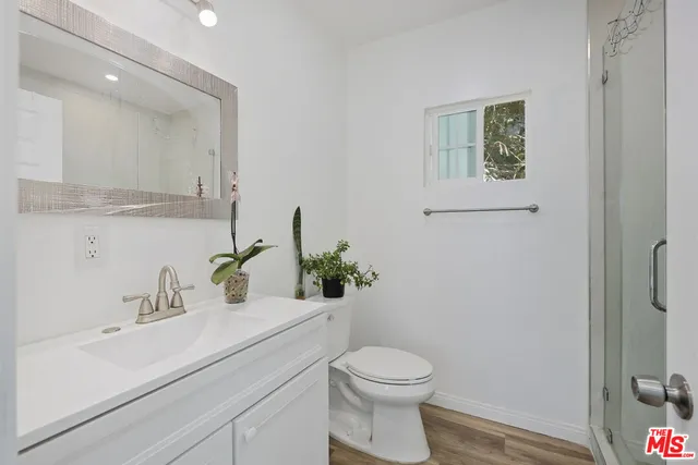 a bathroom with a sink a toilet and mirror
