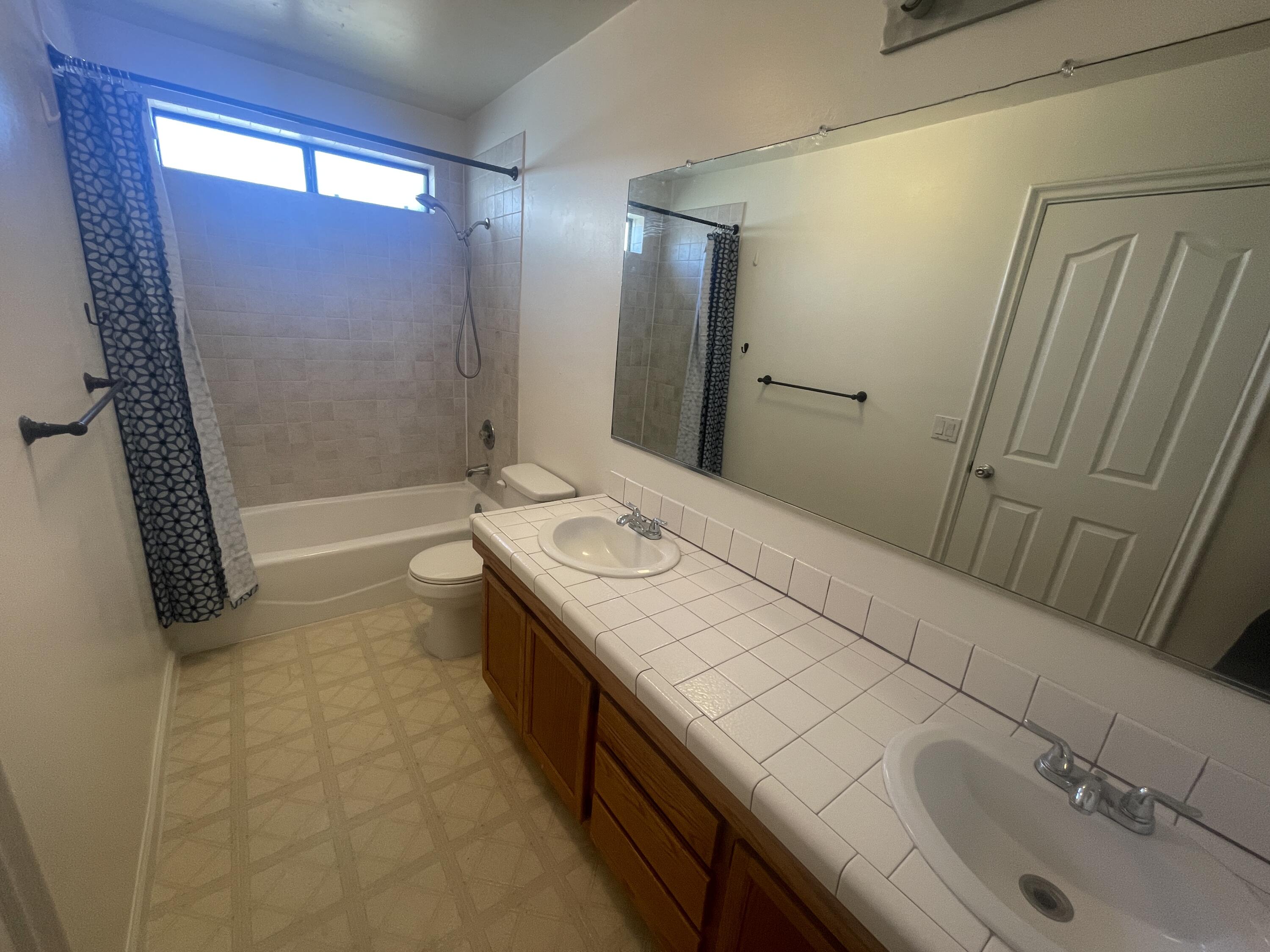 1372 Jenner Street Lancaster, CA 93534 - Photo 6 of 16 a bathroom with a sink a toilet and shower