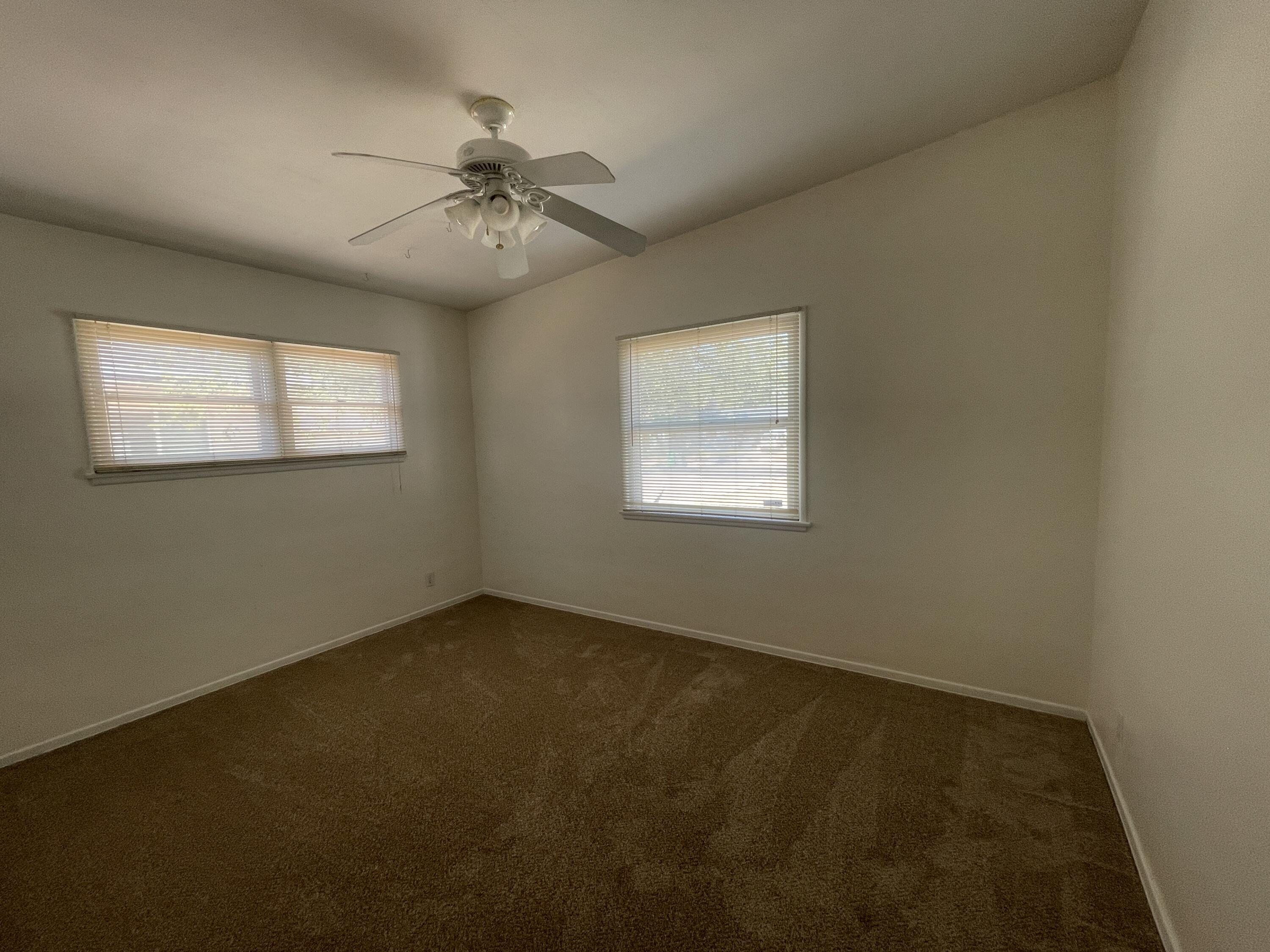 1372 Jenner Street Lancaster, CA 93534 - Photo 8 of 16 an empty room with windows and fan