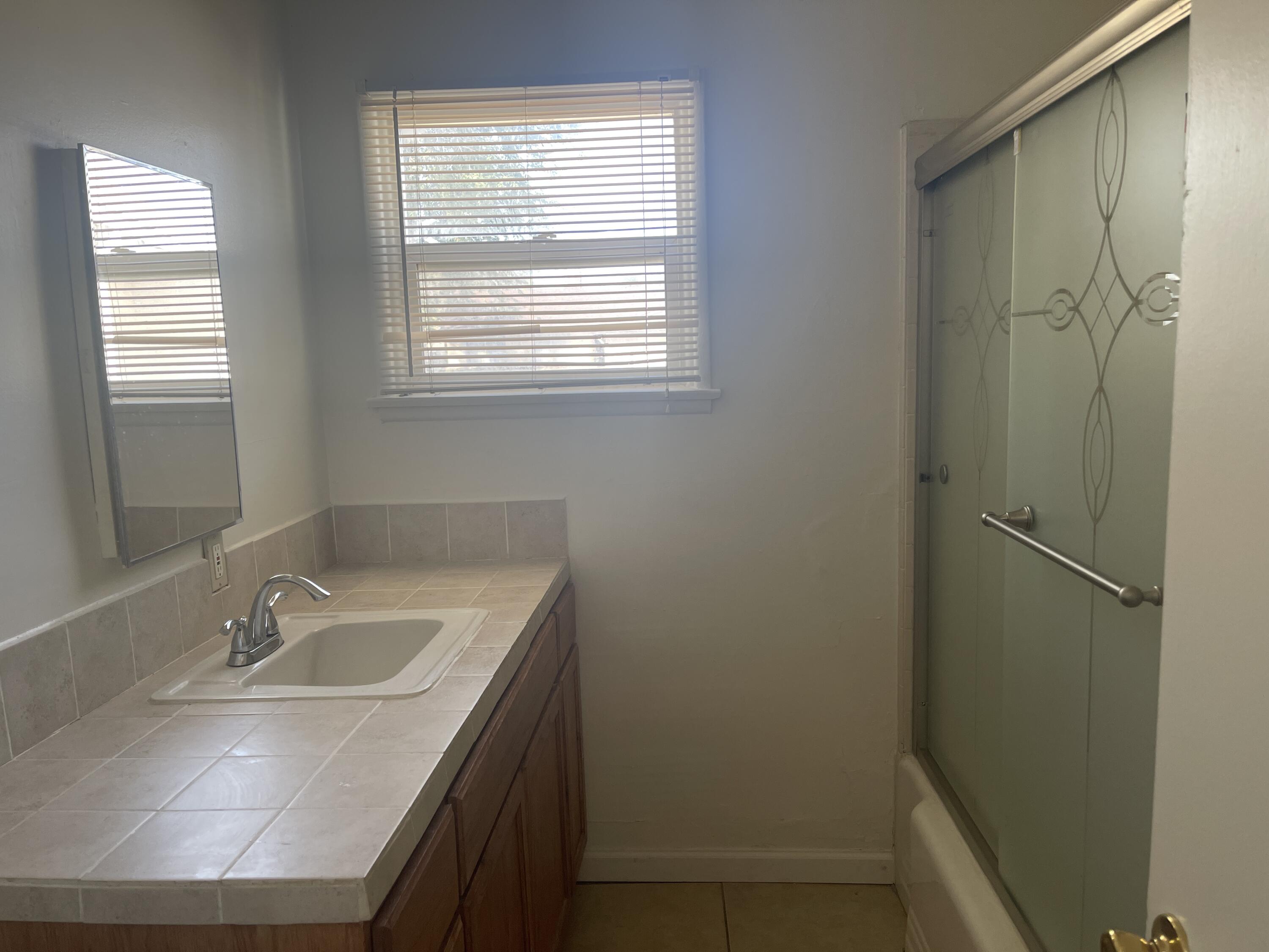 1372 Jenner Street Lancaster, CA 93534 - Photo 9 of 16 a bathroom with a sink a vanity and a mirror