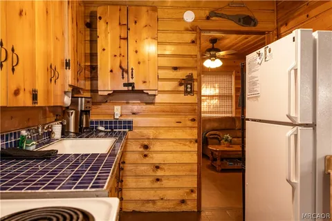 a kitchen with stainless steel appliances a stove a sink and a refrigerator
