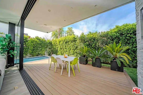 a living room with furniture a flat screen tv and a large window