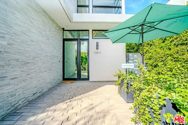 a living room with fireplace furniture and a large window