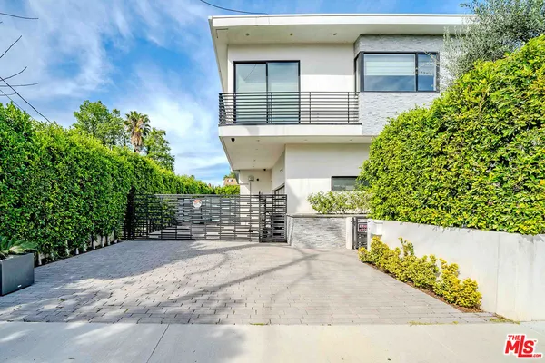 a kitchen with stainless steel appliances kitchen island granite countertop a refrigerator and a sink