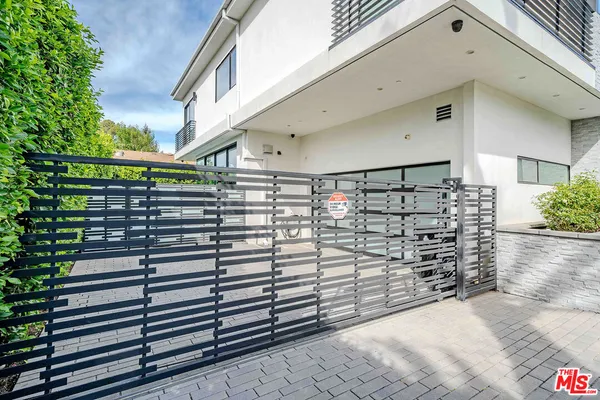 a large white kitchen with lots of counter space wooden floor and appliances