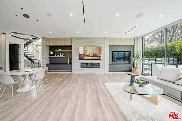 a large kitchen with stainless steel appliances granite countertop a large center island and a wooden floor