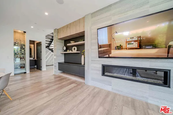 a bedroom with furniture and a flat screen tv
