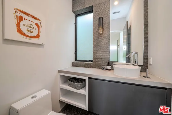 a bathroom with a bathtub sink and mirror