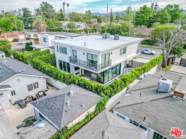 an aerial view of a house with a yard and potted plants