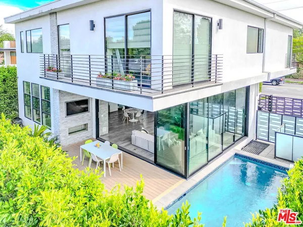 an aerial view of residential houses with outdoor space and street view