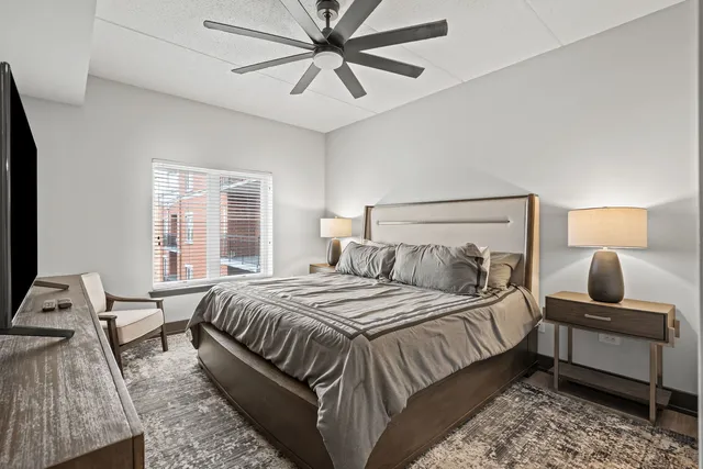 a bedroom with a bed and wooden floor
