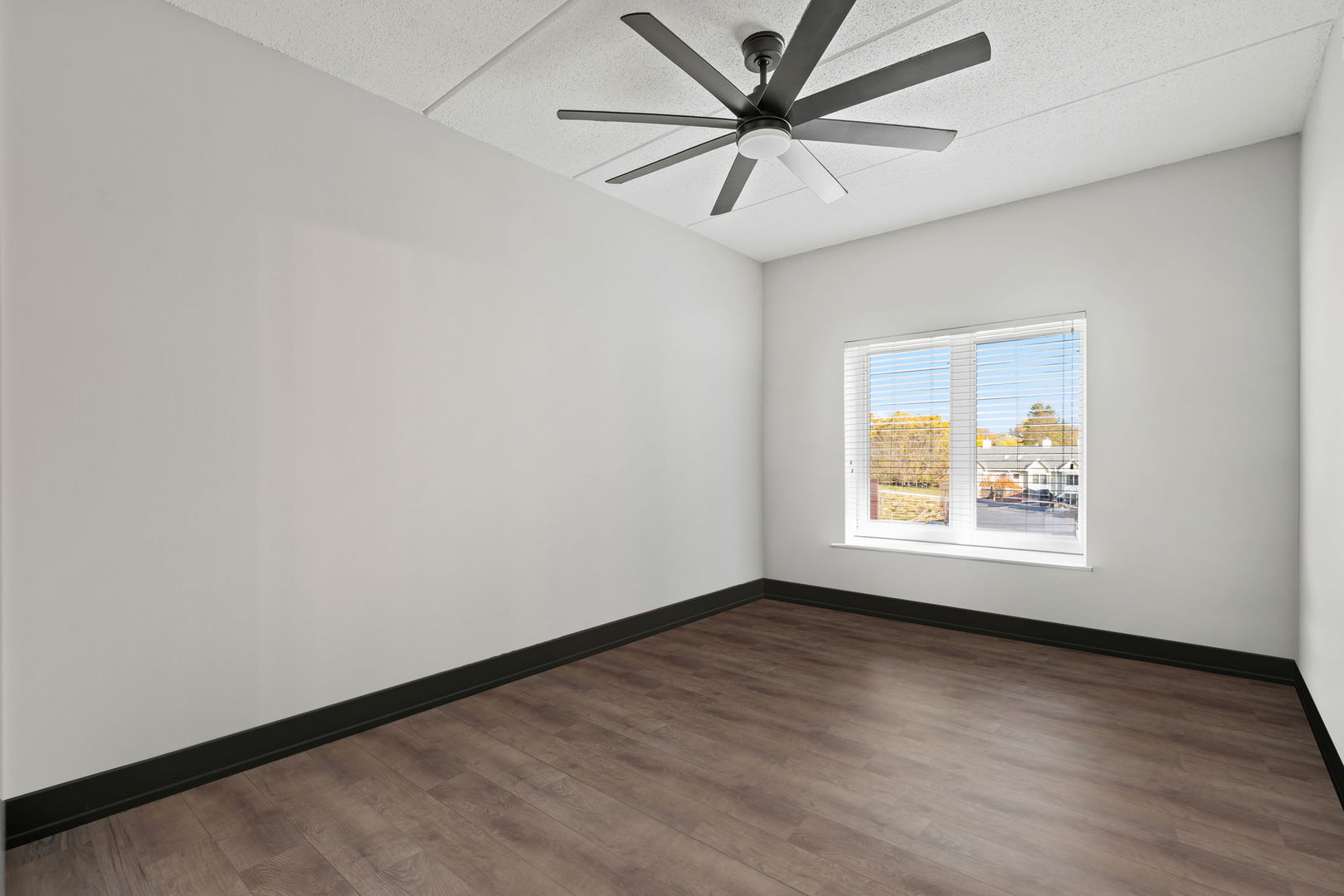 235 North Smith Street, Unit 412 Palatine, IL 60067 - Photo 7 of 18 an empty room with wooden floor and windows