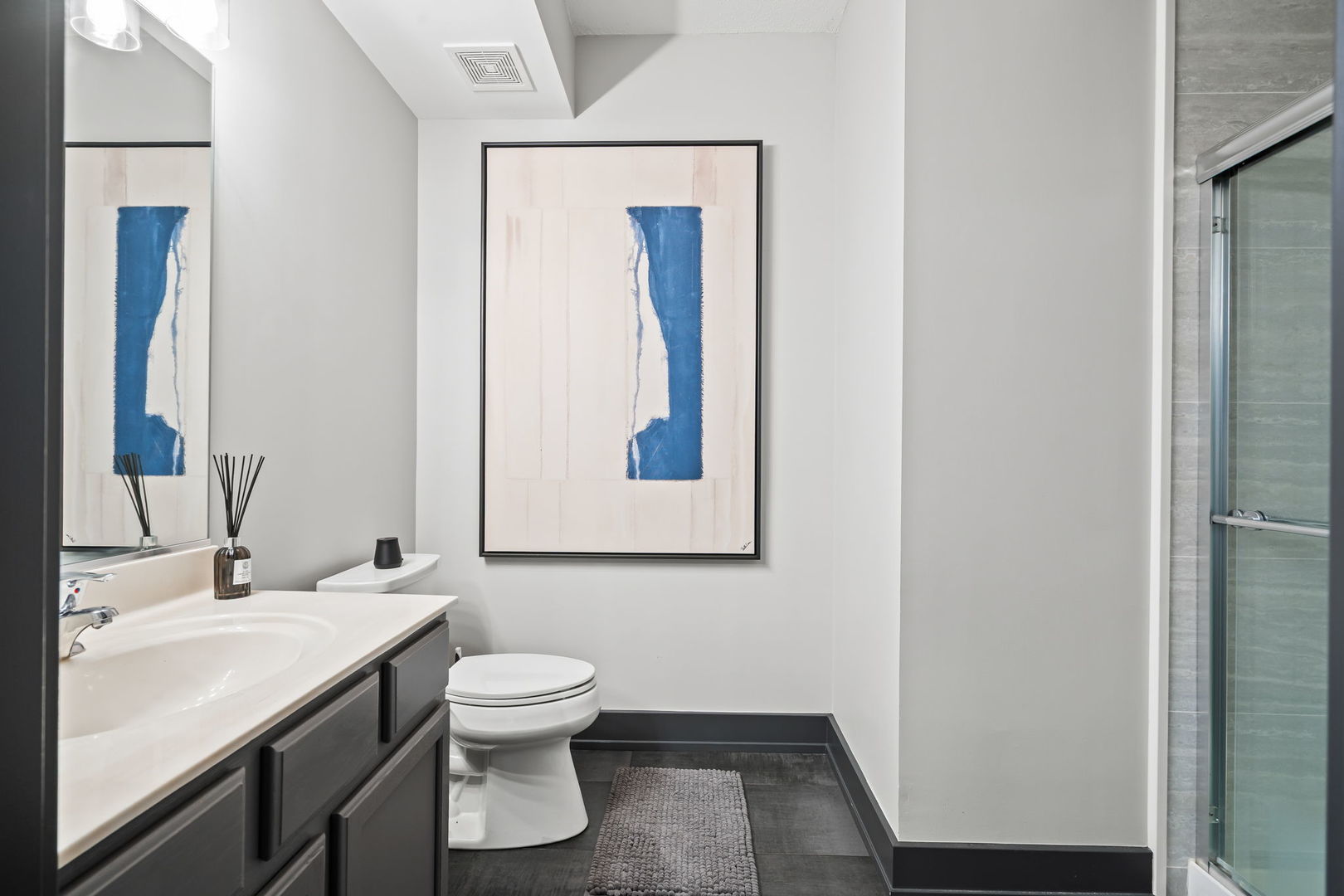 235 North Smith Street, Unit 412 Palatine, IL 60067 - Photo 8 of 18 a bathroom with a toilet sink vanity and mirror