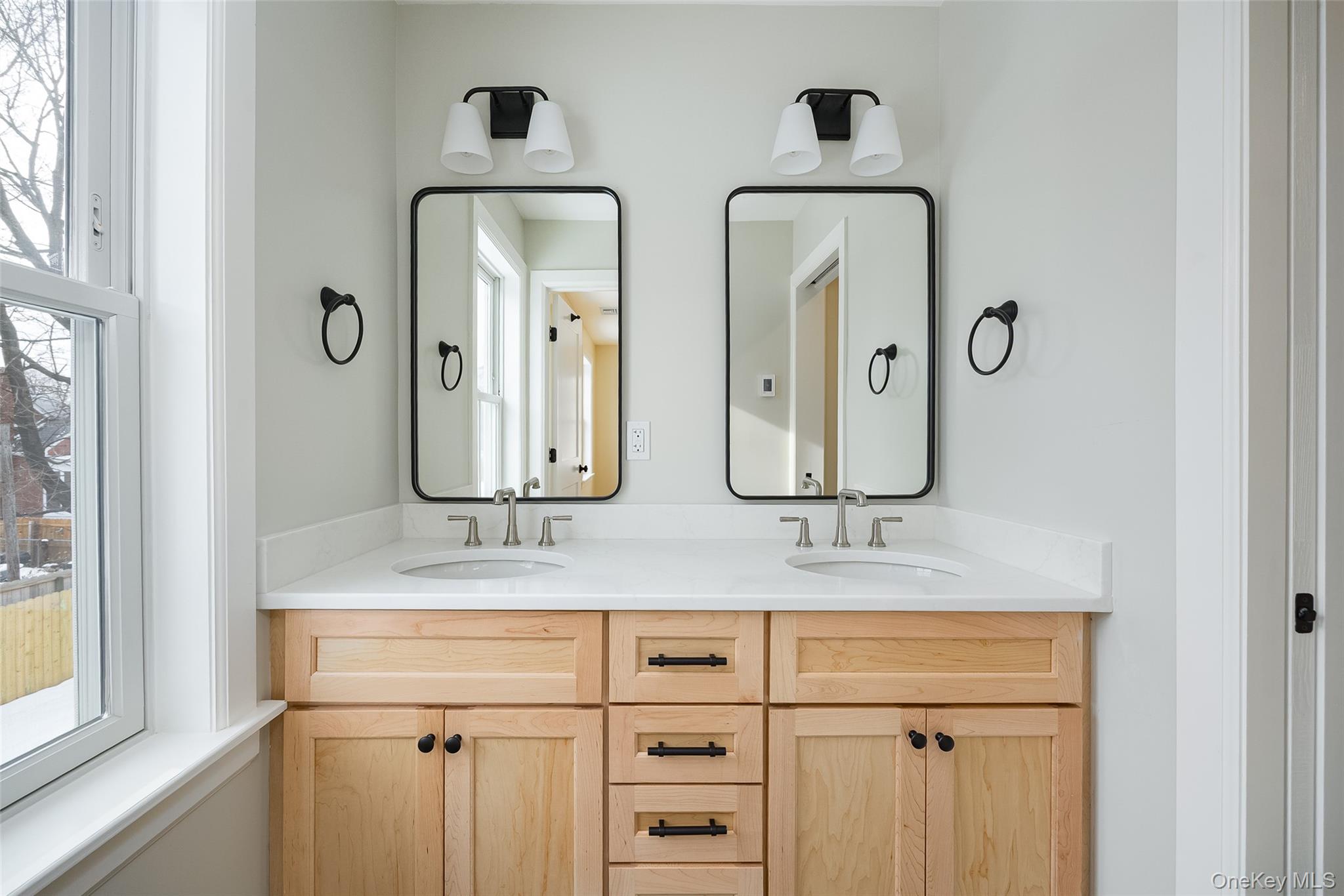 19 Henry Street, Unit 4 Beacon, NY 12508 - Photo 18 of 26 a bathroom with double vanity sink and two mirror
