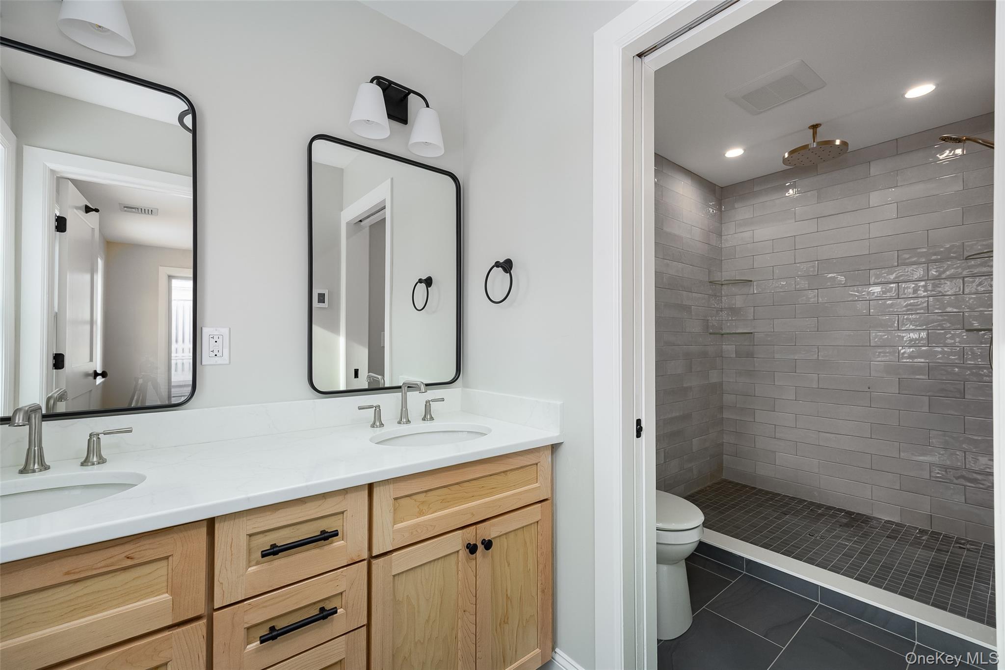 19 Henry Street, Unit 4 Beacon, NY 12508 - Photo 19 of 26 a bathroom with double sink and a mirror