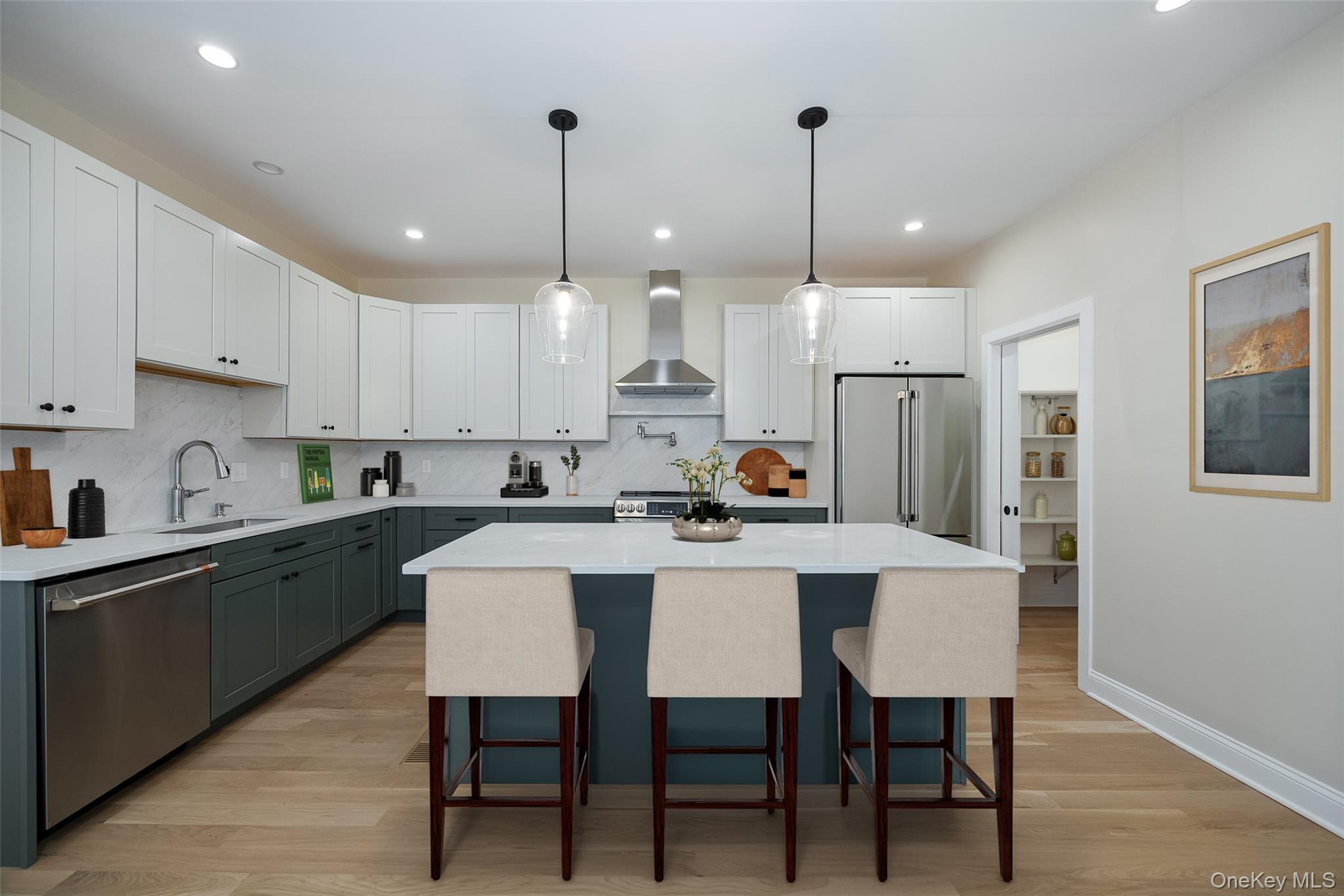 19 Henry Street, Unit 4 Beacon, NY 12508 - Photo 7 of 29 a kitchen with stainless steel appliances kitchen island granite countertop a table chairs sink and cabinets