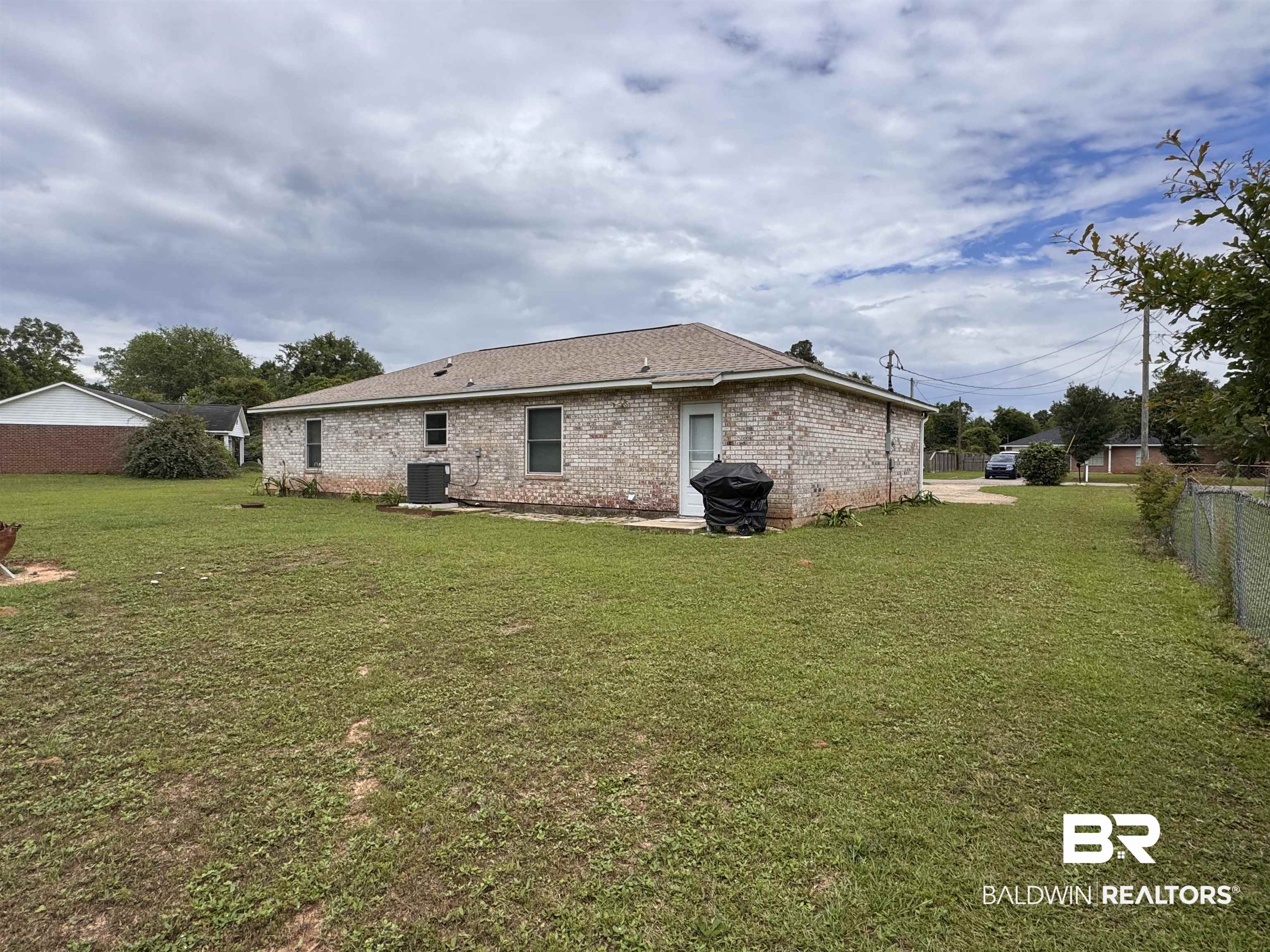 15148 Highland Circle Foley, AL 36535 - Photo 6 of 47 Rear view of property with central AC unit and brick siding