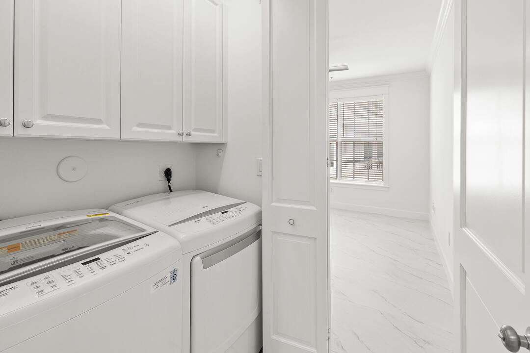 47 Southwest Osceola Street, Unit 206 Stuart, FL 34994 - Photo 24 of 47 a utility room with dryer and washer