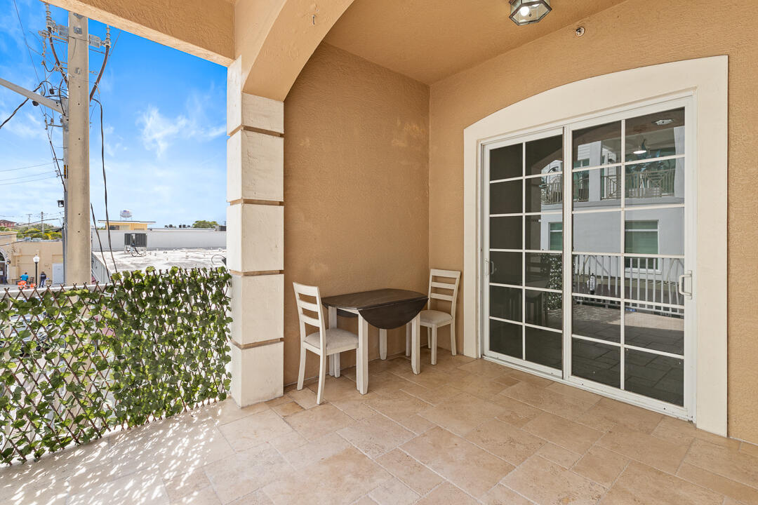 47 Southwest Osceola Street, Unit 206 Stuart, FL 34994 - Photo 28 of 47 a view of a chair and table in the back yard of the house