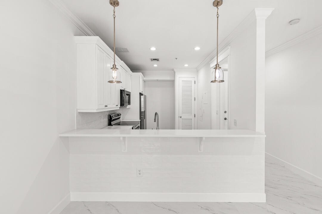 47 Southwest Osceola Street, Unit 206 Stuart, FL 34994 - Photo 3 of 47 a view of a kitchen with a sink and a chandelier