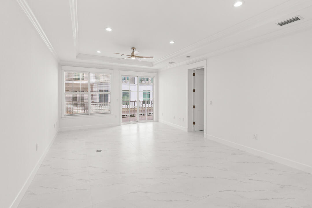 47 Southwest Osceola Street, Unit 206 Stuart, FL 34994 - Photo 4 of 47 an empty room with windows and pillars in it