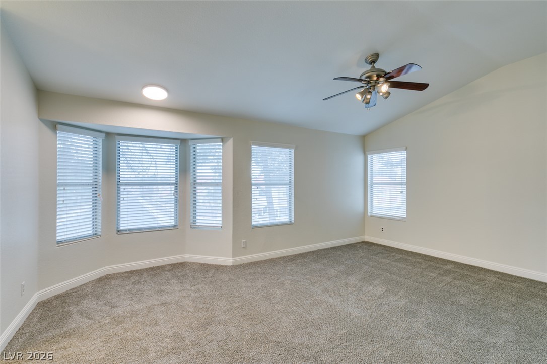 1738 Toltec Circle Henderson, NV 89014 - Photo 25 of 46 Ample natural light illuminates this spacious bedroom, featuring a large bay window and vaulted ceilings.