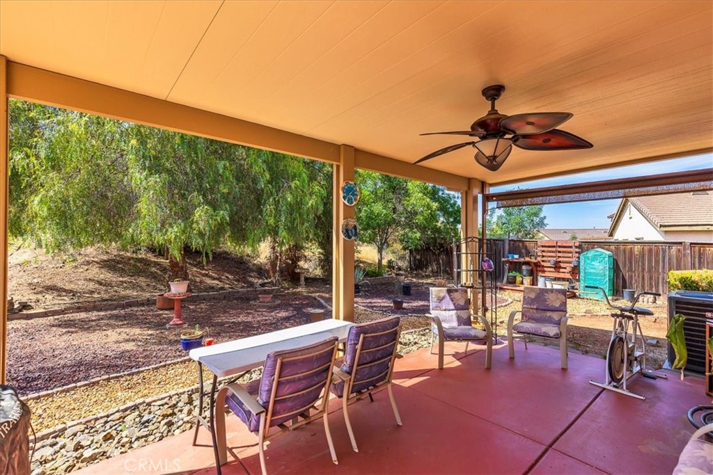 28984 Escalante Road Menifee, CA 92587 - Photo 29 of 40 Covered patio with ceiling fan and light, also shades on both sides