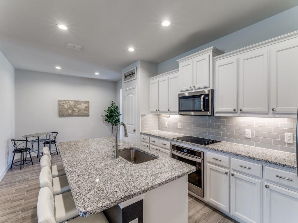 5944 Bursey Road Watauga, TX 76148 - Photo 10 of 25 a kitchen with stainless steel appliances granite countertop a sink stove and cabinets