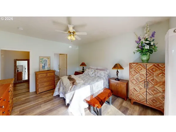 a bedroom with a bed and wooden floor