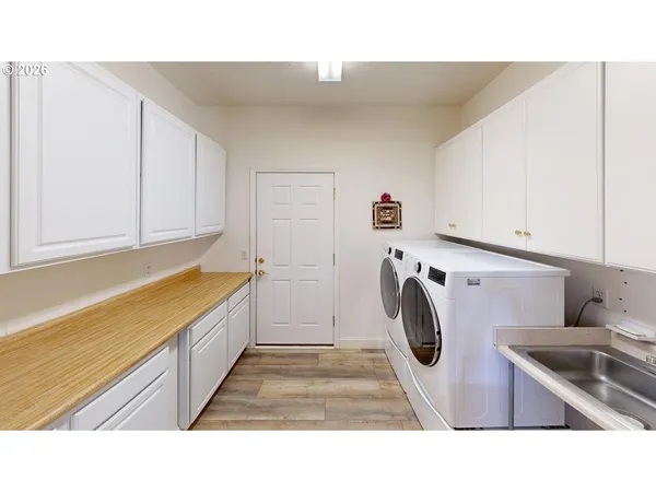 a bathroom with a sink and a washing machine in it