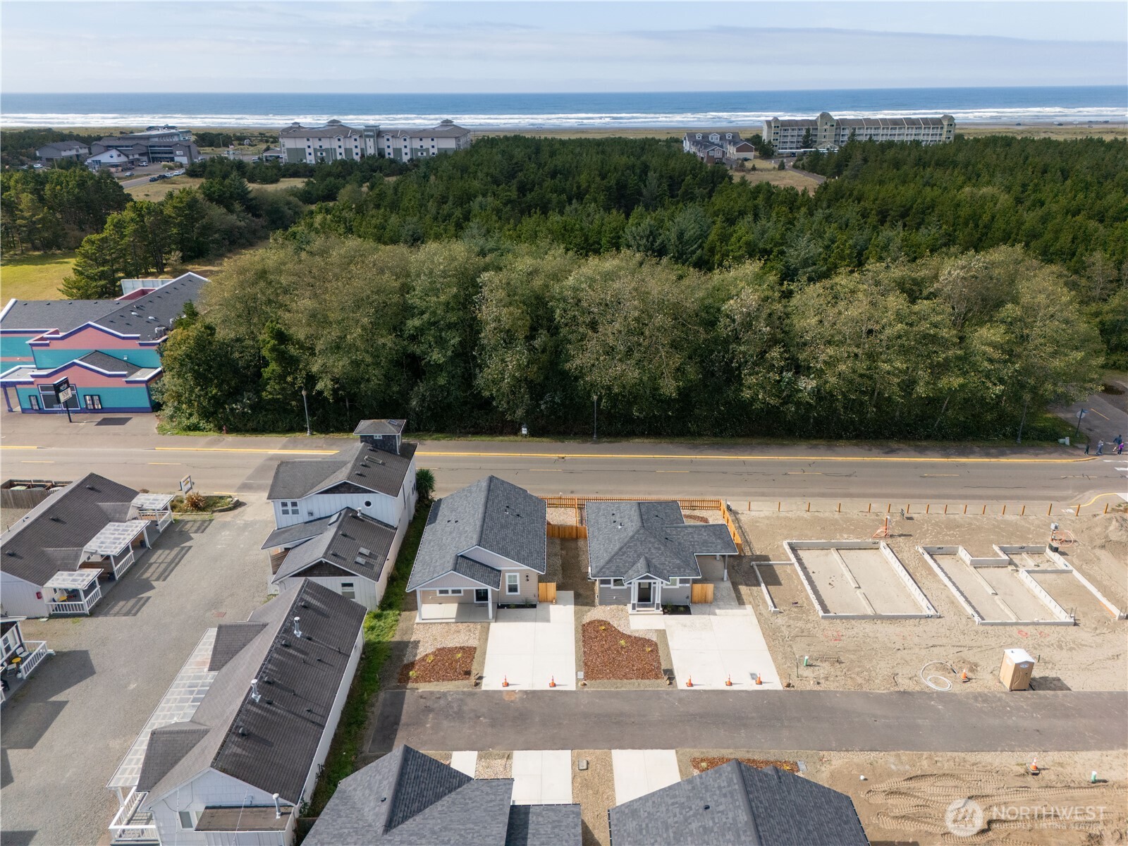 121 7th Street Southwest Long Beach, WA 98631 - Photo 8 of 15 a view of a patio with lawn chairs floor to ceiling window and an outdoor seating