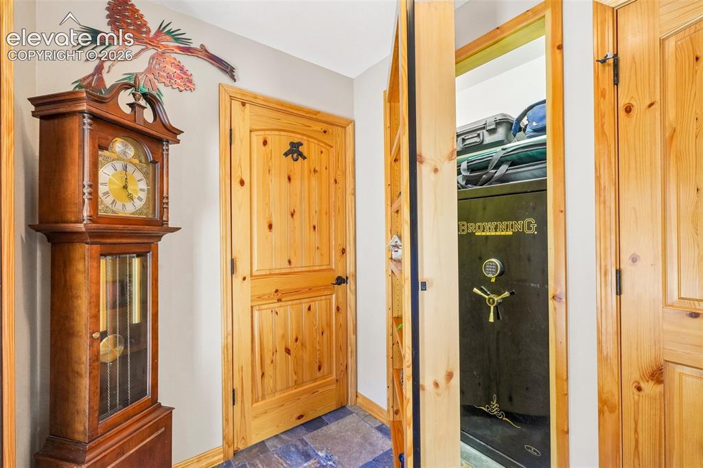 858 Oak Ridge Road Manitou Springs, CO 80829 - Photo 7 of 50 Foyer looking at the 3/4 bathroom and the secret safe room hidden behind a bookshelf