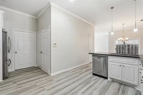 a kitchen with granite countertop white cabinets and white appliances