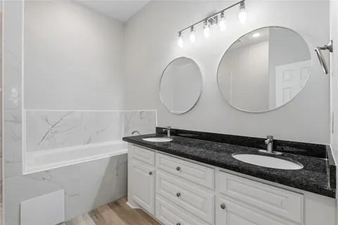 a bathroom with a double vanity sink and a mirror