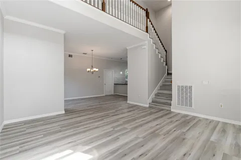 a view of a hallway with wooden floor and entryway
