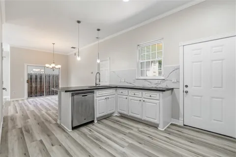 a kitchen with granite countertop cabinets stainless steel appliances a sink and a window