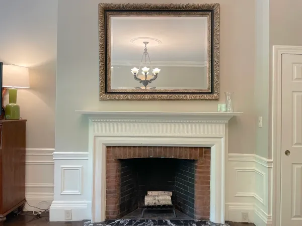 a living room with a fireplace and a wooden floor